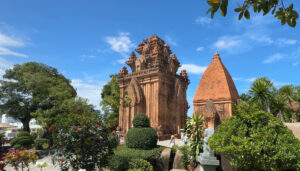 Full exterior view of Ponagar Tower with manicured gardens under a blue sky