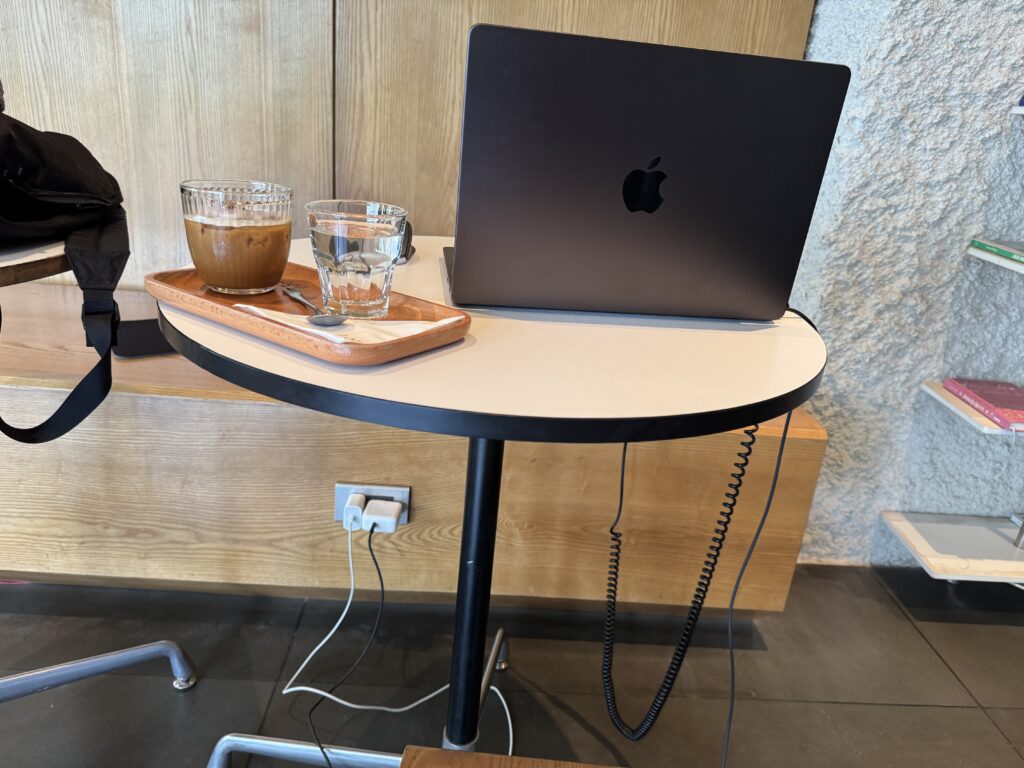 Video editing setup at Bonjour Café using MacBook Pro connected to a UGREEN USB-C hub