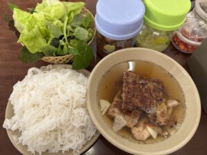 Bun cha set with noodles, dipping sauce, and fresh herbs in Hanoi