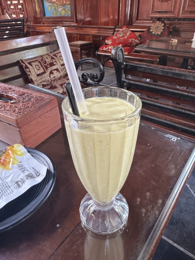 Avocado smoothie served inside a traditional Vietnamese wooden cafe