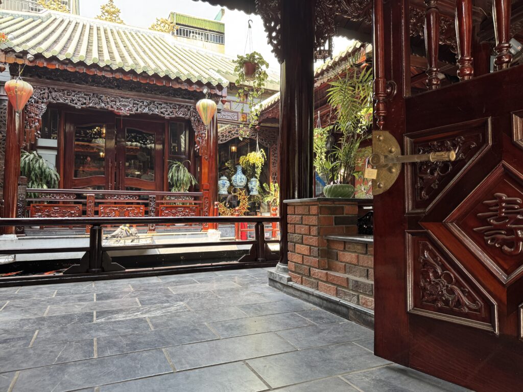 Traditional Vietnamese courtyard cafe with wooden architecture and koi pond