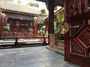 Traditional Vietnamese courtyard cafe with wooden architecture and koi pond