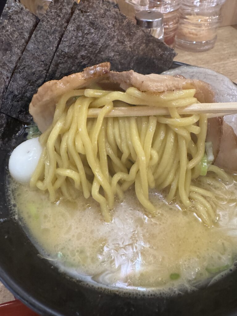 Close-up of thick noodles coated in rich Iekei ramen broth at Tatsuichiya in Hanoi