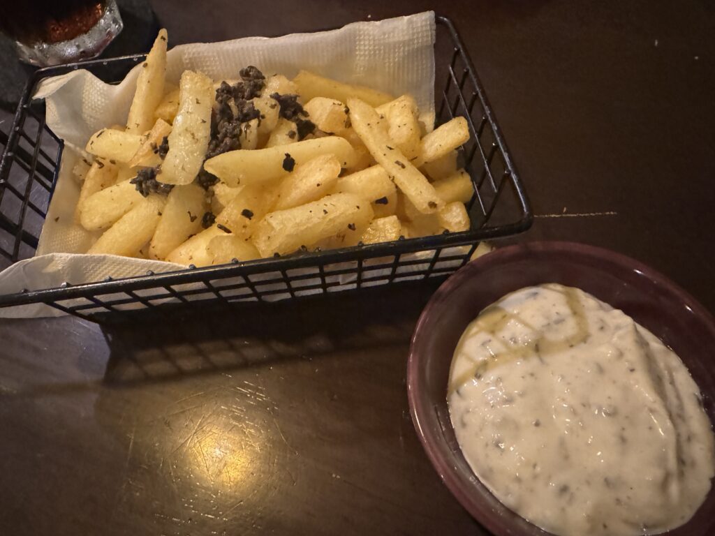 French fries with truffle topping and creamy dipping sauce at Domenica Napoli Pizza
