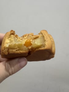 Mooncake cut open to show the filling and egg yolk center from JW Marriott Hanoi